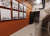 Thumbnail 20 of 37 - a hallway with pictures of dogs on the wall and a stainless steel refrigerator