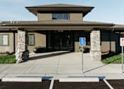 Thumbnail 33 of 37 - the front entrance of a building with a handicapped entrance sign