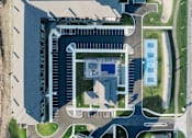 Thumbnail 30 of 37 - an aerial view of a building on top of a parking lot