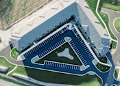 Thumbnail 31 of 37 - an aerial view of a large building with a football field on the roof