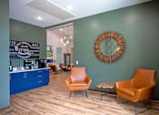 Thumbnail 25 of 37 - A room with a green wall and a framed circular object on the wall.