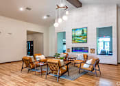 Thumbnail 22 of 37 - A modern living room with a wooden floor and a fireplace.