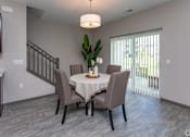Thumbnail 11 of 37 - A dining room with a table set for four.