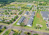 Thumbnail 32 of 37 - A bird's eye view of a residential area with houses, roads, and a park.