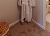Thumbnail 5 of 29 - a white robe hangs on a rack in a closet