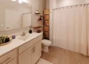 Thumbnail 6 of 29 - a bathroom with a shower and a sink and a toilet