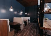 Thumbnail 19 of 29 - a dining room with blue walls and wooden tables and chairs