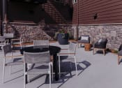 Thumbnail 24 of 29 - a patio with a table and chairs and a fire pit