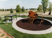 Thumbnail 25 of 29 - a playground with a swing set in a park