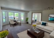 Thumbnail 13 of 28 - a living room and dining room with a white couch and a coffee table