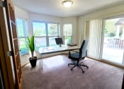 Thumbnail 15 of 28 - a home office with a desk and a computer