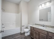 Thumbnail 18 of 36 - A bathroom with a toilet, sink, and bathtub.