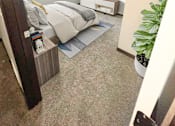Thumbnail 14 of 36 - A bedroom with a bed, nightstand, and a TV on the wall.
