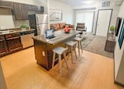 Thumbnail 1 of 36 - A kitchen with a table and chairs in the middle of the room.