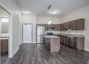 Thumbnail 4 of 36 - A kitchen with a white door and a counter.