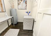 Thumbnail 21 of 36 - A small room with a white table and a white cabinet.