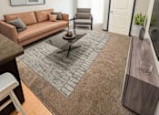Thumbnail 8 of 36 - A living room with a brown couch and a grey rug.