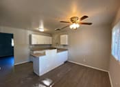 Thumbnail 10 of 11 - A room with a ceiling fan and a counter at Root River Apartments, Greendale, 53129
