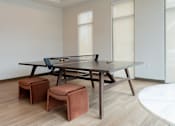 Thumbnail 9 of 22 - A table with a pool table on top and two stools at Alta Apartments, Pewaukee, WI 53186