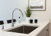 Thumbnail 16 of 22 - A modern kitchen with a sink at Alta Apartments, Wisconsin 53186