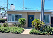 Thumbnail 8 of 16 - A house with a blue door and a garage.