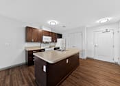 Thumbnail 6 of 46 - A kitchen with brown cabinets and a countertop.