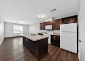 Thumbnail 7 of 46 - A kitchen with white appliances and brown cabinets.