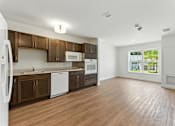 Thumbnail 3 of 66 - A kitchen with brown cabinets and white appliances.