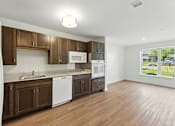 Thumbnail 19 of 66 - A kitchen with brown cabinets and white appliances.