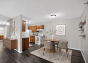 Thumbnail 14 of 32 - A modern kitchen with a dining table and chairs.