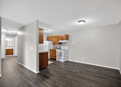 Thumbnail 18 of 32 - A kitchen with white appliances and wooden cabinets.