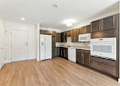 Thumbnail 2 of 66 - A kitchen with white appliances and brown cabinets.