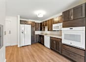 Thumbnail 16 of 66 - A kitchen with white appliances and wooden cabinets.