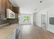 Thumbnail 6 of 66 - A modern kitchen with wooden floors and a large window.