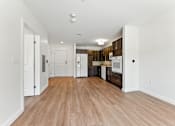 Thumbnail 11 of 66 - A kitchen area with white cabinets and a wooden floor.