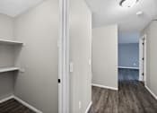 Thumbnail 21 of 32 - A room with a white door and a grey wall.