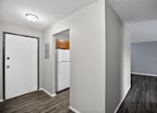Thumbnail 20 of 32 - A white door is on the left of a kitchen area.