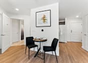 Thumbnail 41 of 66 - A dining room with a table and two chairs.