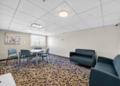Thumbnail 5 of 23 - A conference room with a table and chairs.