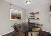 Thumbnail 2 of 32 - A dining room with a glass table and chairs.