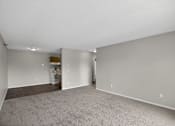Thumbnail 7 of 32 - A spacious room with a carpeted floor and a white ceiling.