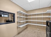 Thumbnail 8 of 23 - Empty room with shelves and a mirror on the wall.