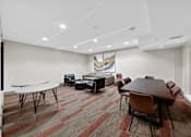 Thumbnail 19 of 46 - A conference room with a long table and chairs.