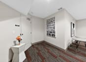Thumbnail 21 of 46 - A room with a white table and a chair.