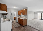 Thumbnail 3 of 32 - A kitchen with brown cabinets and a white stove.