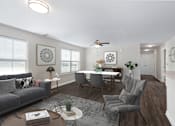 Thumbnail 3 of 7 - A living room with a grey sofa, a grey armchair, a wooden coffee table, a white dining table, and a ceiling fan.