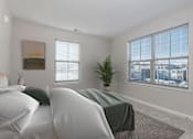 Thumbnail 1 of 7 - A bedroom with two beds and a large window.