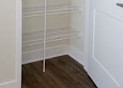Thumbnail 28 of 28 - Empty white shelves in a white pantry.