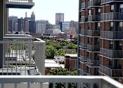 Thumbnail 17 of 28 - A cityscape is seen from a balcony.