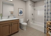 Thumbnail 9 of 11 - A bathroom with a toilet, sink, and bathtub.